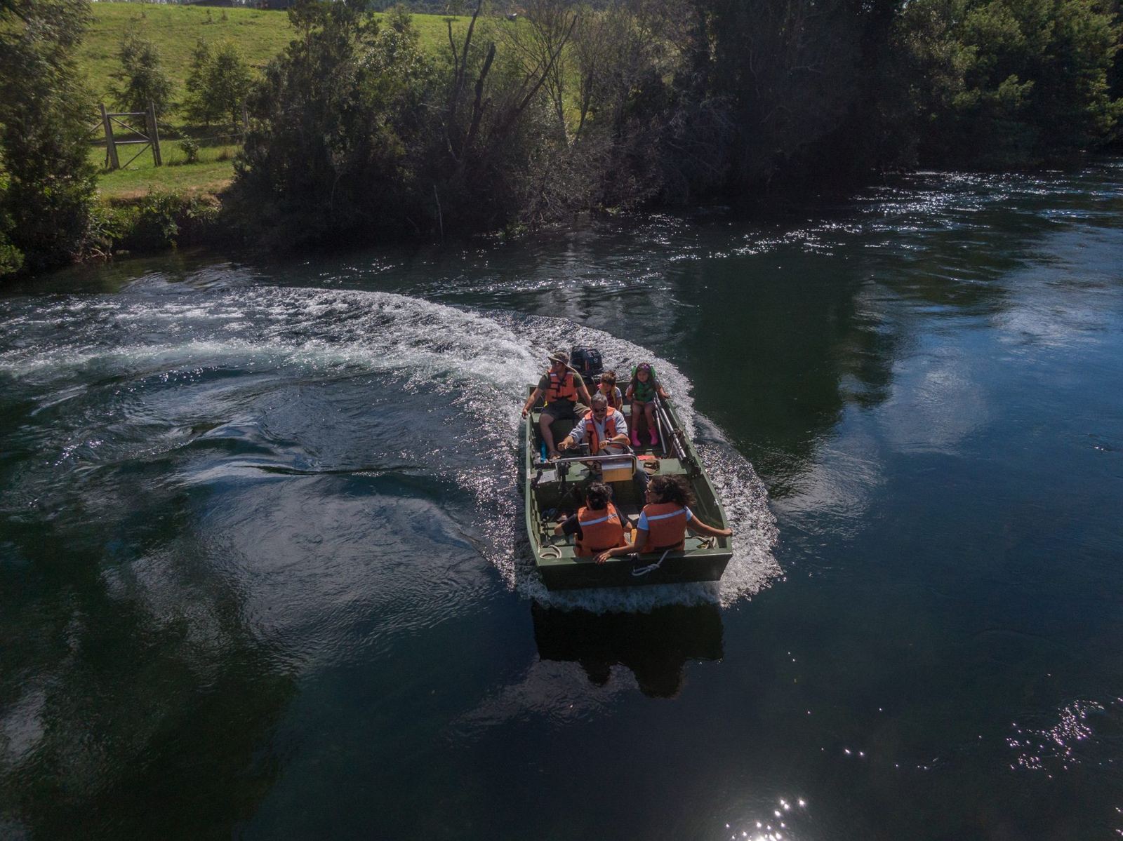 Barco Río Maullín navegando com uma família a bordo, vista aérea, com coletes salva-vidas